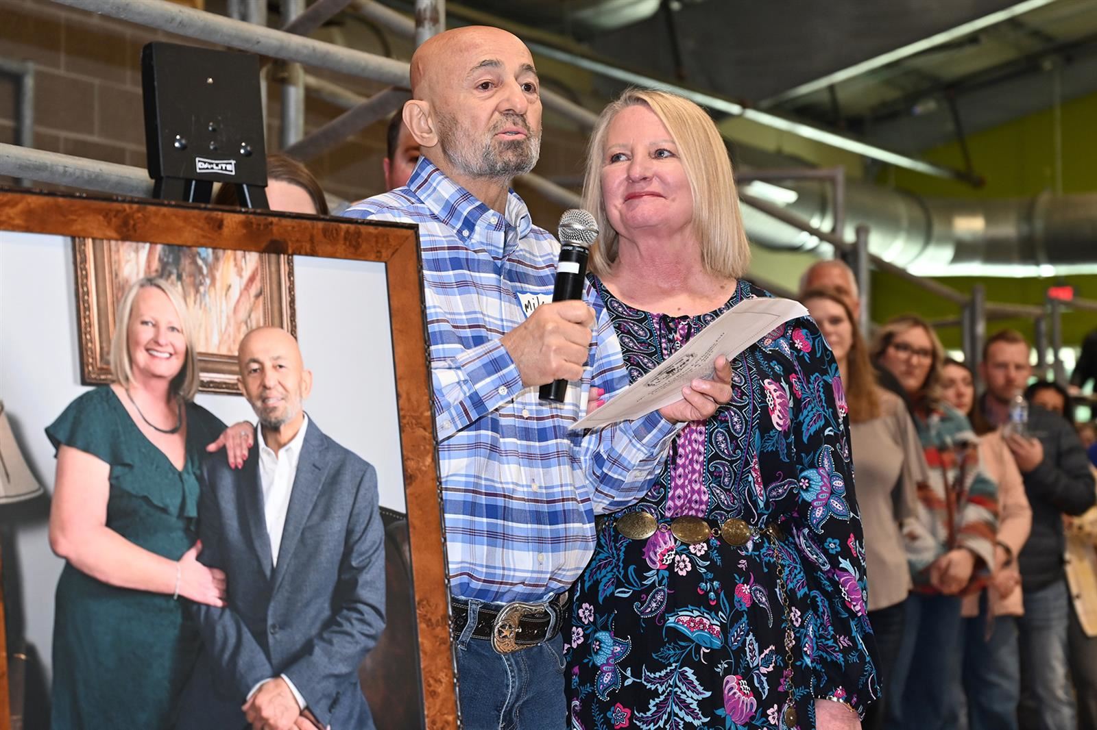 Mike and Darlene Jarrar speak following the unveiling of a portrait before the CFISD Livestock Show Association Show and Sale